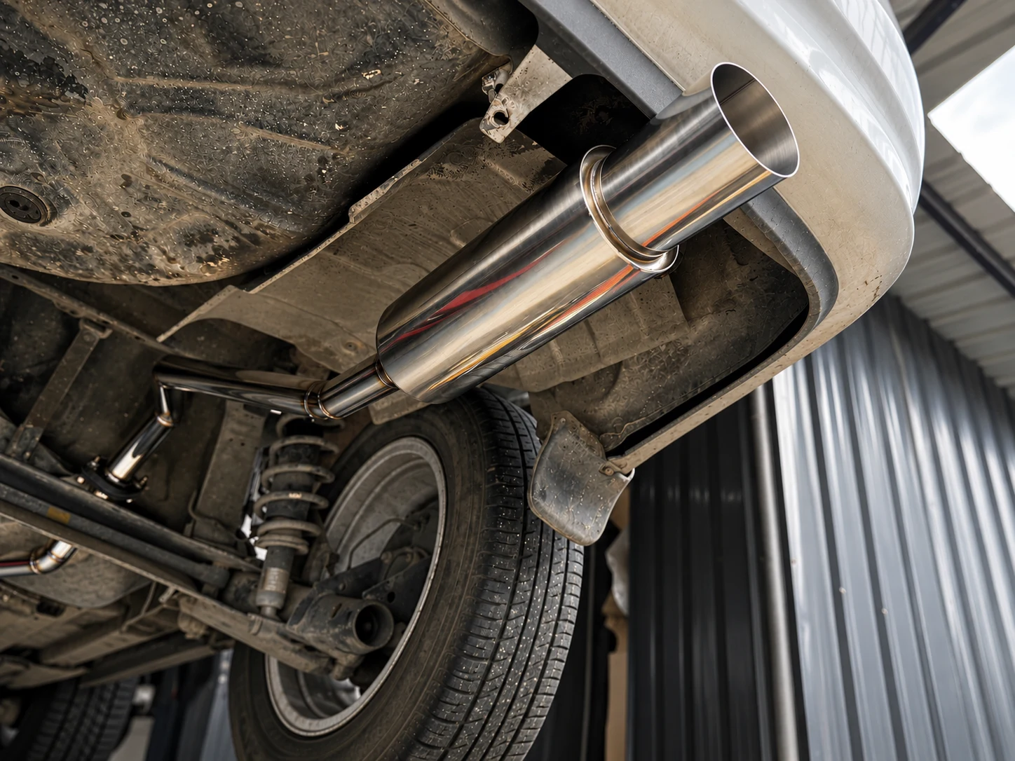 A muffler under a lifted vehicle