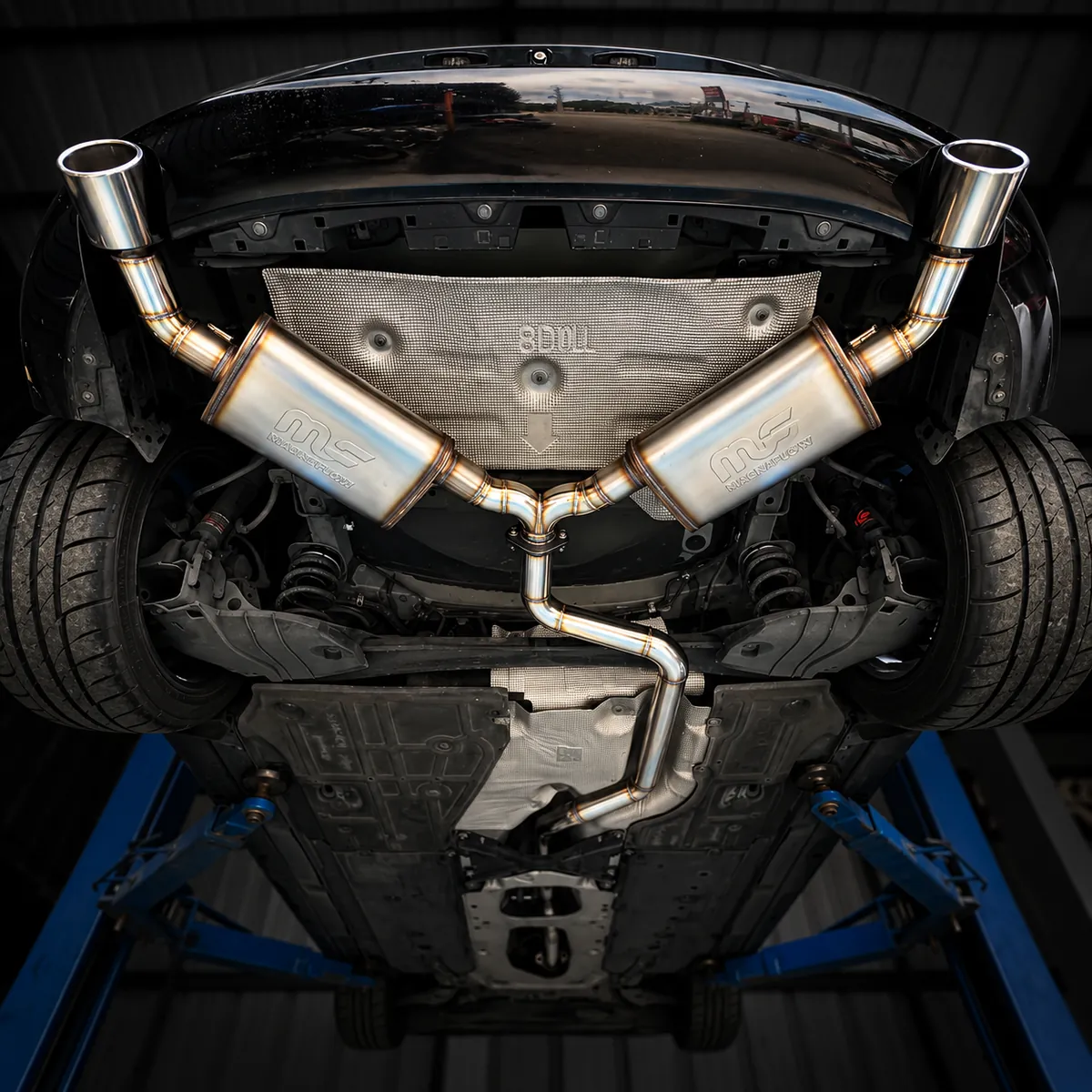 Dual catback with a single midpipe under a sports car